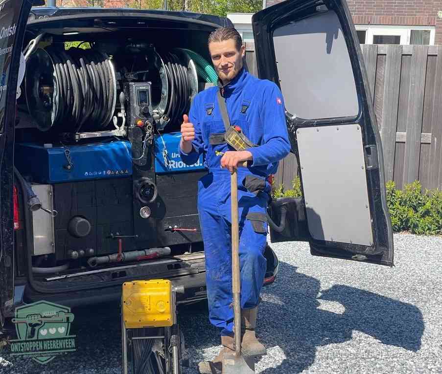 Een tevreden monteur met opgestoken duim naast de bestelbus, slim ingrijpen bespaart kosten bij een verstopte afvoer in Heerenveen